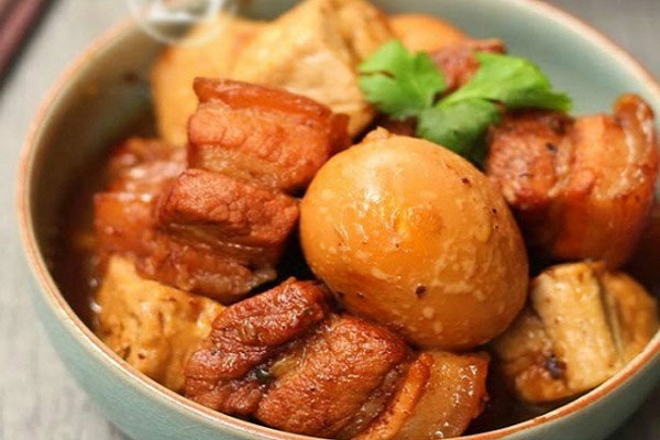 close up of pork and eggs in caramel sauce in a bowl